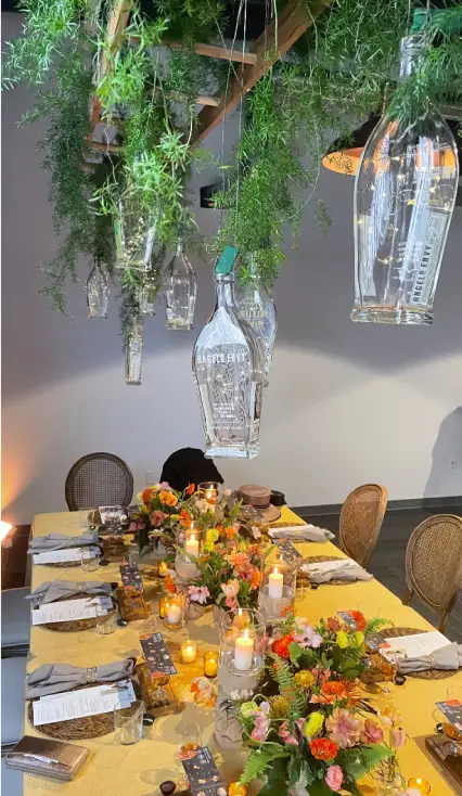 A dining table adorned with Angel’s Envy bottles and decorations