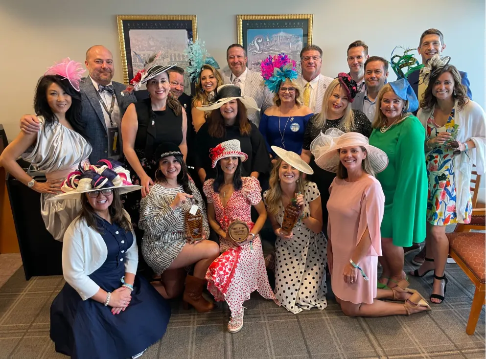 A group photo of individuals wearing Kentucky Derby gear