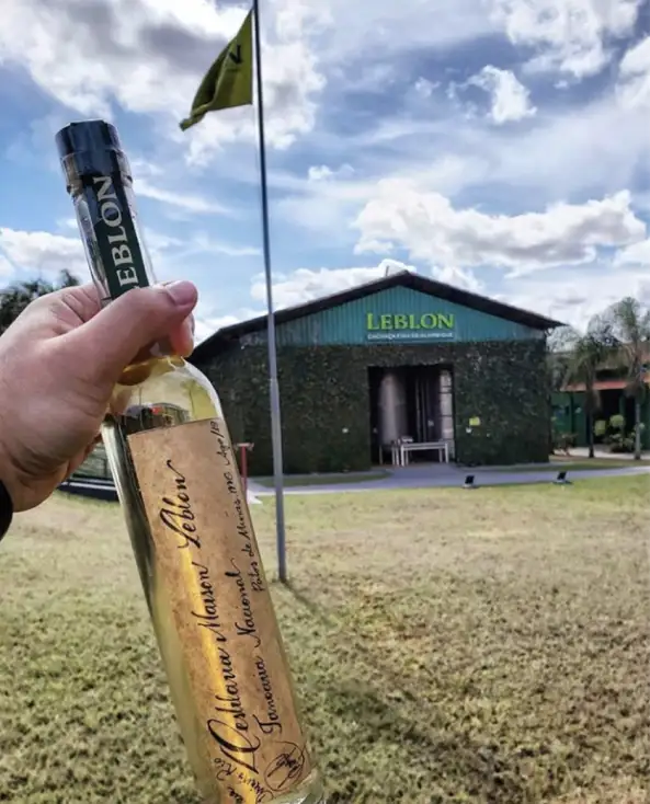 A photo of a bottle of Leblon outside of the Leblon distillery